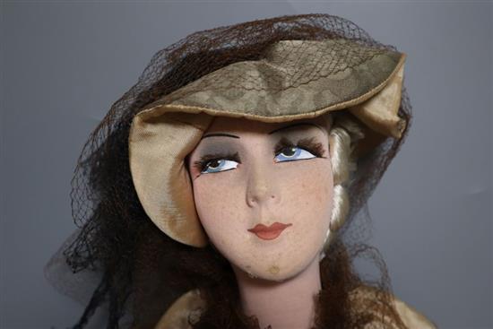 A painted felt and composition fashion doll, 75cm high with silk and taffeta dress